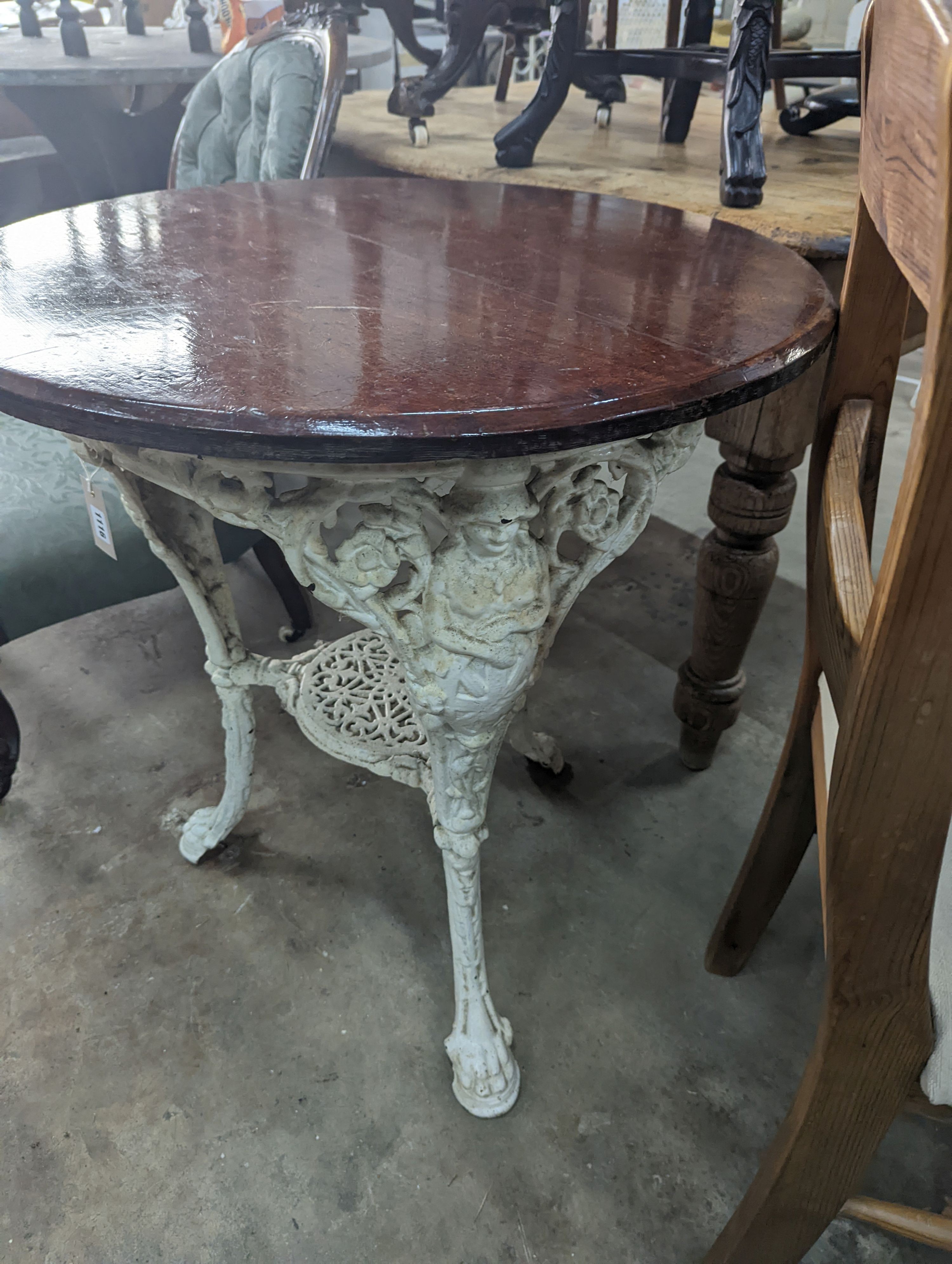 A Victorian white painted cast iron Britannia pub table with circular mahogany top, diameter 66cm, height 74cm